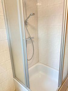 a shower with a glass door in a bathroom at Walatoll in Norden +12 photos