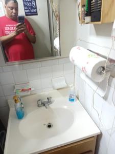 a woman taking a picture of a bathroom sink at Anderson home services in Woodlawn