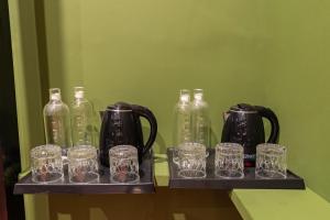 a group of glass jars and bottles on a shelf at Versailles Backpacker Hostel in Pondicherry