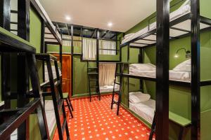 a room with several bunk beds in it at Versailles Backpacker Hostel in Pondicherry