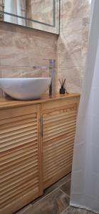 a bathroom with a sink on top of a wooden cabinet at Poduszka mini-hotel in Stantsiya Rokitno Volynskoye