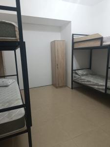 a room with two bunk beds and a cabinet at Urban hostel Saryarka in Astana