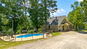 a house with a swimming pool in front of a house at Trailhead Lodge in Eureka Springs