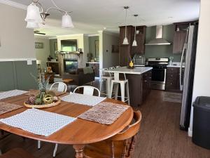 a kitchen and living room with a table and chairs at Belvidere Mountain Vista Home by Stowe Jay Peak Smuggs Long Trail in Belvidere Center
