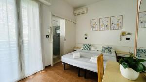 a small room with a bed and a table at Albergo Villa Denny in Rimini