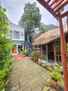 a house with a stone walkway in front of a building at Coastal daisy Beach resort in Cox's Bazar