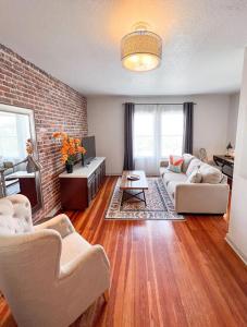 a living room with two couches and a brick wall at Artisan Downtown in De Land