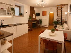a kitchen and living room with a table and chairs at Il Focolare in Subiaco
