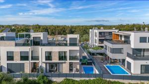 an aerial view of a building with a swimming pool at Boho Beach House Srima in Srima