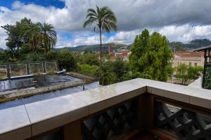 a balcony with a view of a city at Cavi Rooms 304 in Cuenca