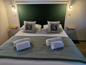 a large bed with two white pillows on it at Les Nuitées de Bois Renaud Chambre d'Hôtes LA FORET in Marcilly-en-Gault