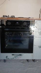 an oven with its door open on a counter at Guest House FAIZ homestay in Panjakent +13 photos