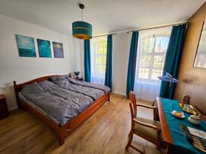 a bedroom with a bed and a dining table at Templomdomb Apartmanház in Tapolca