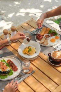 a wooden table with plates of food on it at Soluna Siquijor Boutique Resort in San Juan +24 photos