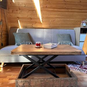 a living room with a table and a couch at Cottage and sauna hill silence mestia 2 in Mestia +29 photos