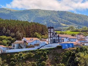 a small town on a hill with a church at Terra Vivaz - Porto Bay Formosa in Porto Formoso