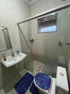 a bathroom with a shower and a toilet and a sink at Casa Carregosa in São Roque +6 photos