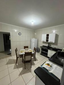 a kitchen with a table and chairs in a room at Casa Carregosa in São Roque