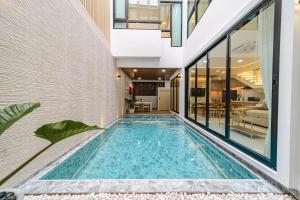 a swimming pool in the middle of a house at Serene Pool Villa Pattaya 2 in Pattaya