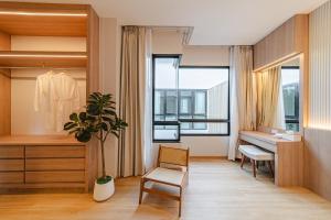 a room with a desk and a chair and a dressing room at Serene Pool Villa Pattaya 2 in Pattaya +41 photos