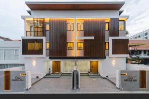 a building with a bunch of doors on it at Serene Pool Villa Pattaya 2 in Pattaya