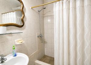 a bathroom with a shower curtain and a sink at Casa RAU-JO in Guaymallen +13 photos