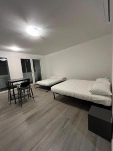 a room with two beds and a table and chairs at Nova Stay in Rome
