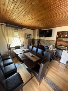 a dining room with a wooden table and chairs at Meandri Ćehotine in Pljevlja