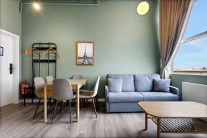 a living room with a couch and a table at ASKA Hraun in Hafnarfjörður