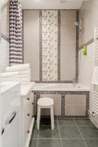 a bathroom with a sink and a tub and a stool at Au Moulin d'Or in Lille +25 photos
