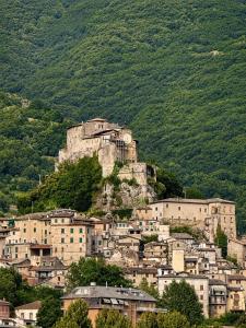 a town on top of a mountain with houses at Il Focolare in Subiaco