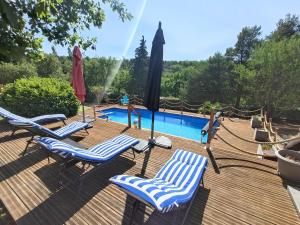 a deck with lounge chairs and a swimming pool at " LE CHABASSOLE " CHAMBRES D'HÔTES - GORGES du VERDON in Aiguines