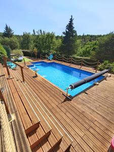 a large wooden deck with a swimming pool at " LE CHABASSOLE " CHAMBRES D'HÔTES - GORGES du VERDON in Aiguines
