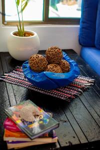 a table with a blue bowl of cookies on it at Hostal Loco Coco Loco in Panama City