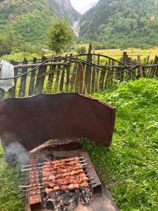 a grill with a bunch of food on it at Jemal Guest House in Cholashi