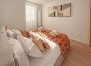 a large white bed with two stuffed animals on it at Terra Vivaz - Porto Bay Formosa in Porto Formoso