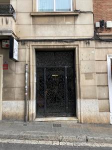 a large black door on the side of a building at Monrooms Barcelona in Barcelona