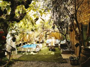 a patio with couches and chairs in a backyard at Casa Jardin Huesca Ciudad in Huesca