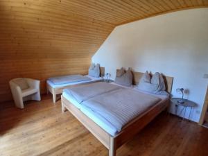 a bedroom with two beds in a wooden room at Enzianhütte Gerlitzen Kanzelhöhe in Kanzelhöhe