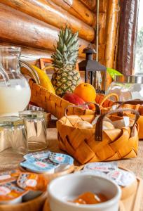 a table with baskets of fruit and a bowl of milk at Habitacion en Cabañas Bella vista in Bella Vista