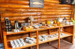 a table with cups and plates and food on it at Habitacion en Cabañas Bella vista in Bella Vista +24 photos