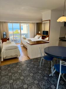 a hotel room with two beds and a table and a table at Ivamar Hotel & Apart in Ostende
