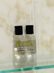 two bottles of shampoo sitting on top of a shelf at Ride Side Delton Hotel in Blackpool