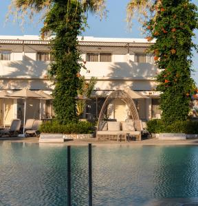 a hotel with a swimming pool and a building at Kouros Palace Active Lifestyle Hotel in Mastihari +92 photos