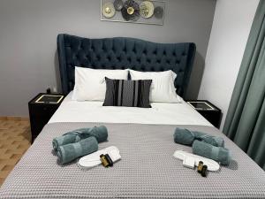 a bed with towels and pillows on it at Markella STONE & LIGHT Skoutari-Mani in Skoutari
