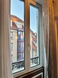 a window with a view of a city at Appart 3 pièce hyper centre Strasbourg in Strasbourg