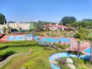 a resort with two pools with people in them at Il Rustico Guesthouse in Lessona