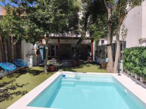 a swimming pool in a yard with trees at Apartamento Guadalvivir in Mogón