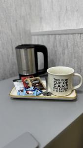 a tray with a coffee mug and a cup on it at Ava Hostel Yerevan in Yerevan