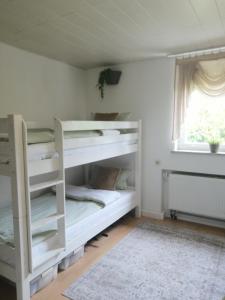 a bedroom with two bunk beds with a window at Thomas Haus 1 in Günzburg